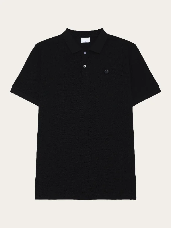 Update your look for less with men’s clothing on sale.  Basic badge polo - Black Jet