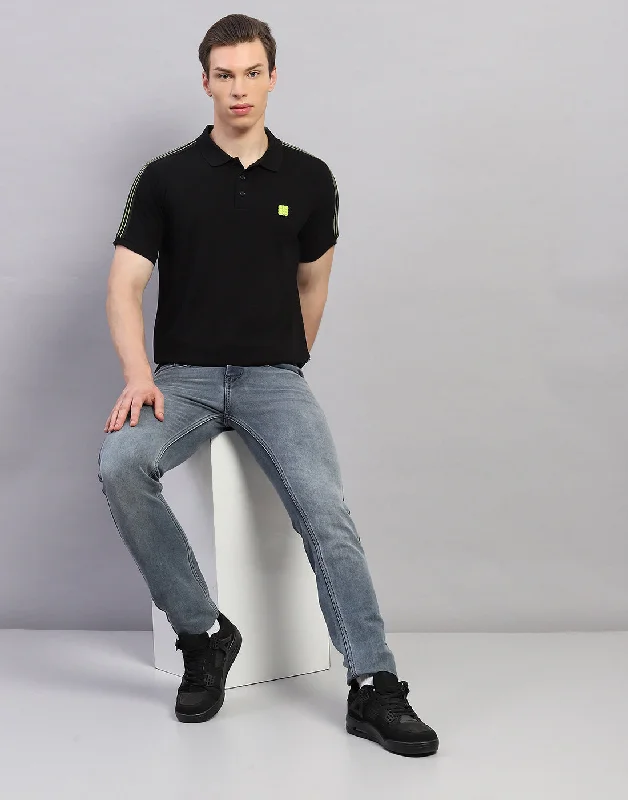 Limited-time promo – up to 70% off on men's essentials.  Men Black Solid Polo Collar Half Sleeve T-Shirt